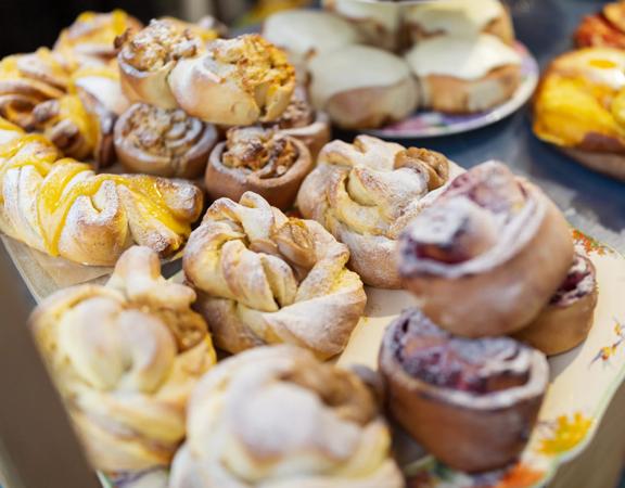 Stacks of baked twists and scrolls sit on decorative plates.