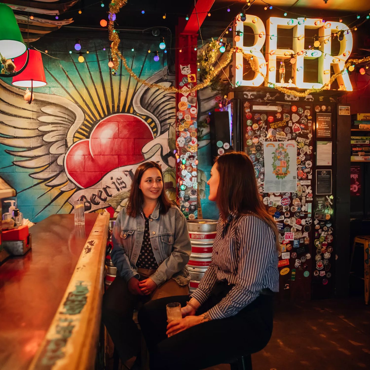 Two people enjoying drinks at Golding's Free Dive, a cool, kitsch, and cosy laneway bar in Te Aro, Wellington.