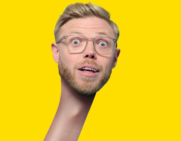 Rob Beckett with a stretched neck on a yellow background.