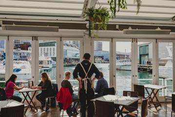 Customers enjoy their meals inside Dockside on the Queens Wharf in Wellington.