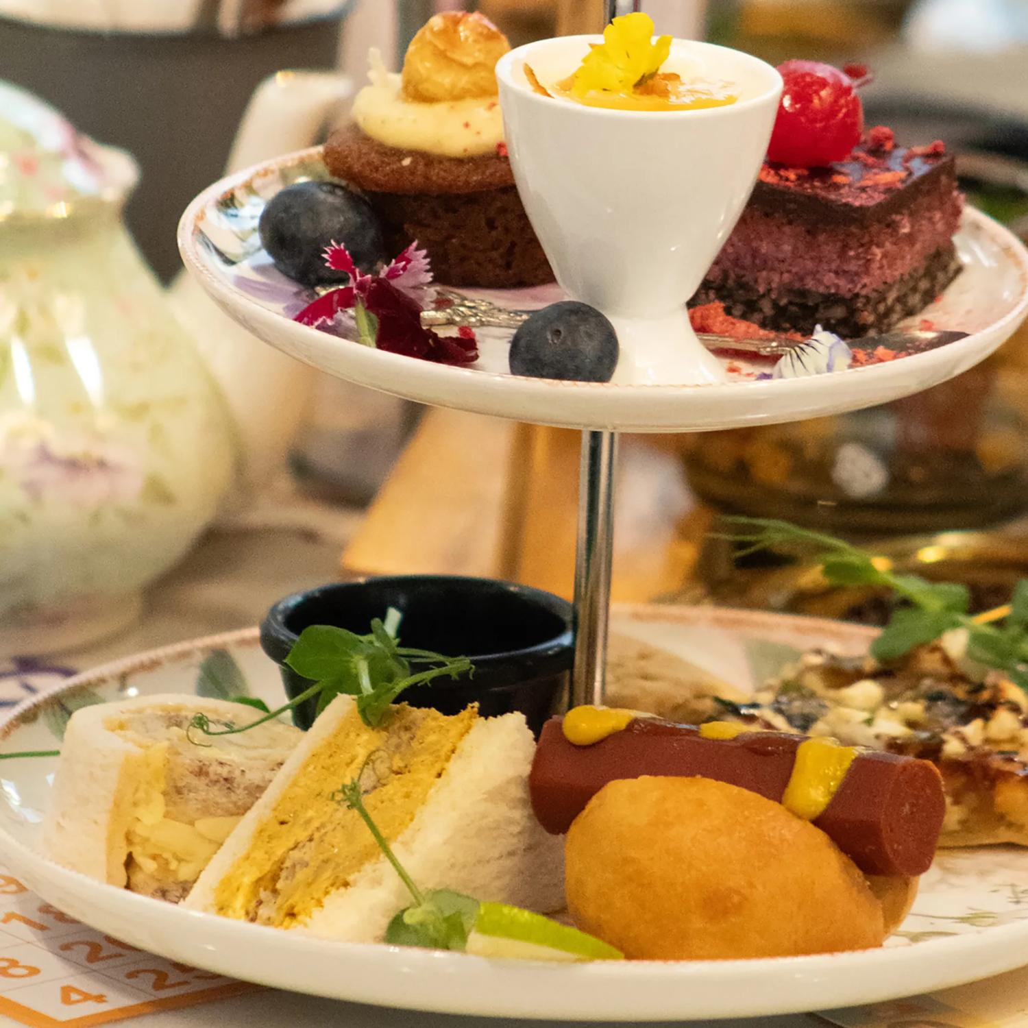 A cake stand holds finger food for high tea.