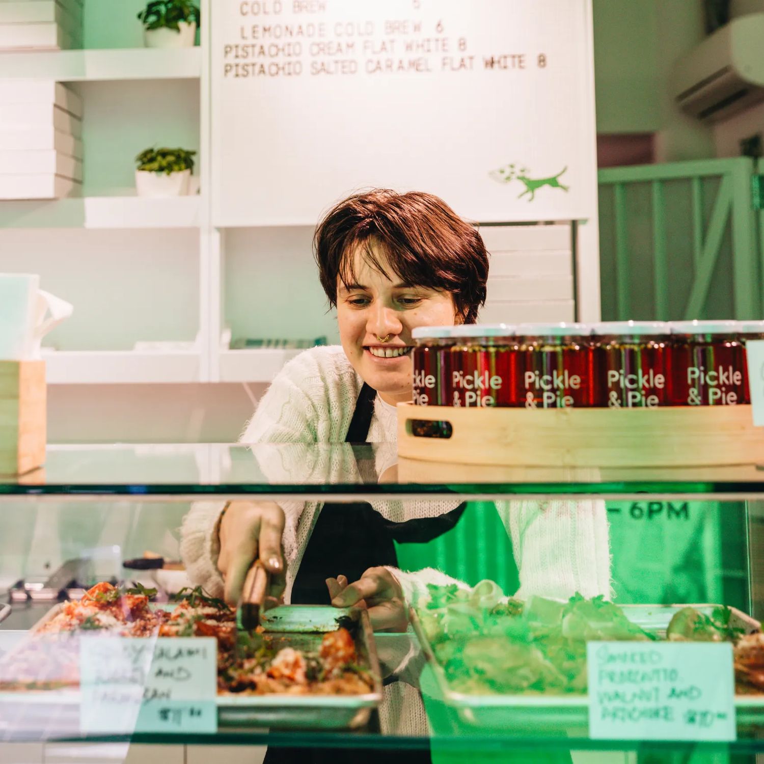 Person at Slice serving up a slice of pizza