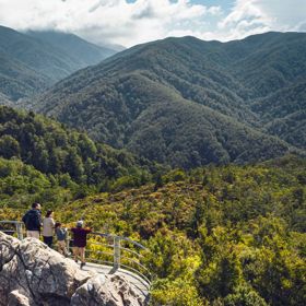 Two adults and two children are at the Rocky Lookout, on Mount Holdsworth in the Tararua Forest Park.