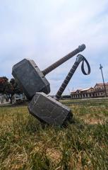 Life size Thor hammer in the foreground with a giant Thor hammer in the background.