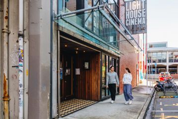 Two friends walk into Light House Cinema Cuba in Te Aro, Wellington.