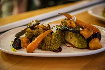 A plate of roasted root vegetables on an oval-shaped white plate.