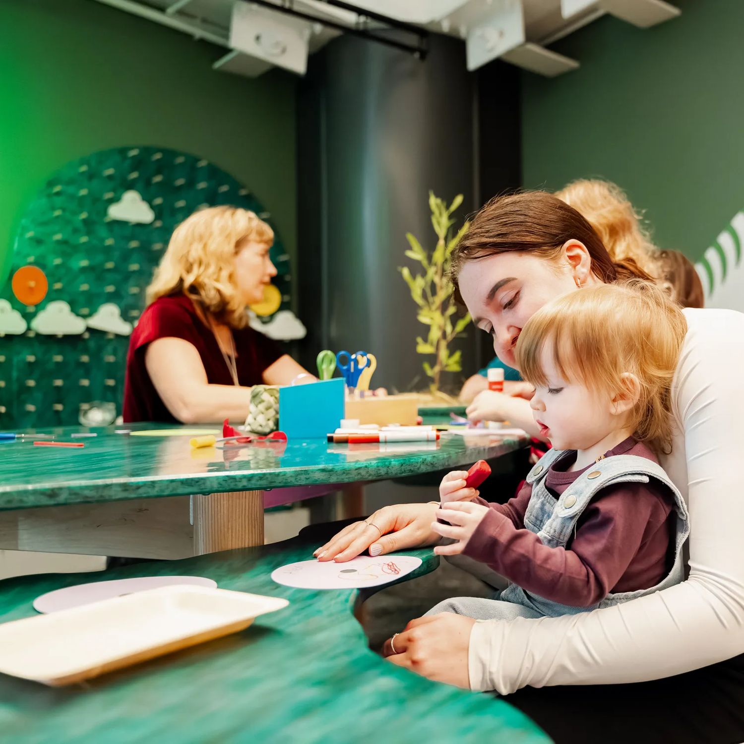 A child and a caregiver using an art station at Capital E in Wellington