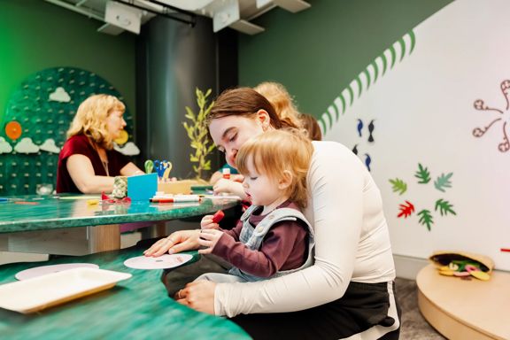 A child and a caregiver using an art station at Capital E in Wellington