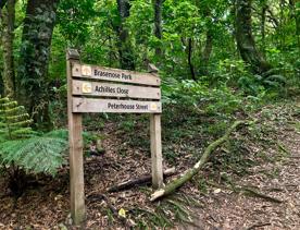 A sign showing directions in the Redwood bush loop.