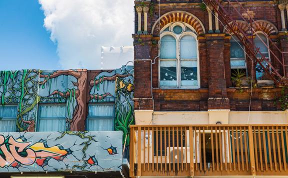 Upwards shot of the second story graffiti and windows of Cuba street.