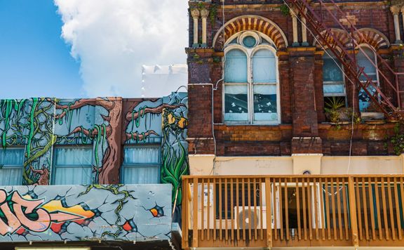 Upwards shot of the second story graffiti and windows of Cuba street.