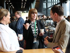 Three people networking at a business event.
