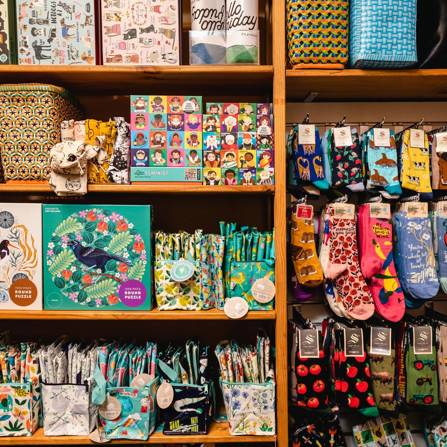 On the right of the picture are colourful kiwiana themed socks, and the left are kiwiana jigsaw puzzles.