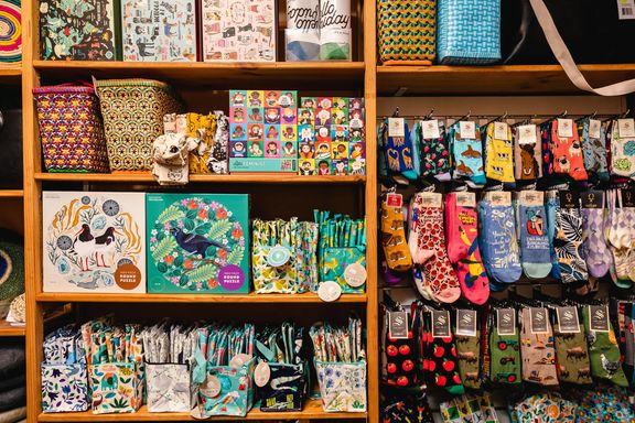 On the right of the picture are colourful kiwiana themed socks, and the left are kiwiana jigsaw puzzles.