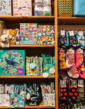 On the right of the picture are colourful kiwiana themed socks, and the left are kiwiana jigsaw puzzles.
