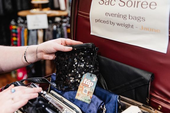 A person thrift shopping at Frip Vintage.