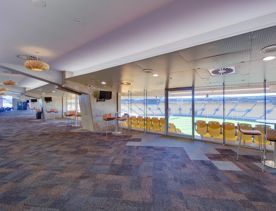 The large open space of the Hnry Stadium Function centre members clubroom looking over the field and stands.