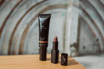 Girl Native branded BB cream and lipstick on a table.
