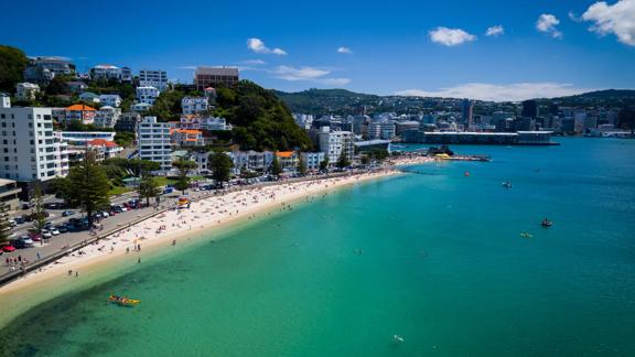 
Drone shot of the busy beach front at Oriental Parade with Wellington City behind.
