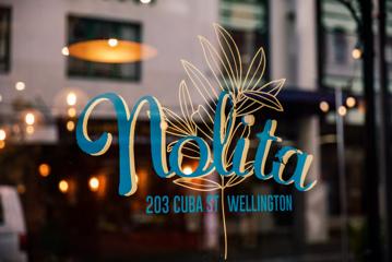 A decal that says 'Nolita' on a window.