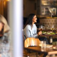 Two people enjoying food and wine at Kisa, a Mediterranean restaurant on Cuba Street in Te Aro, Wellington.