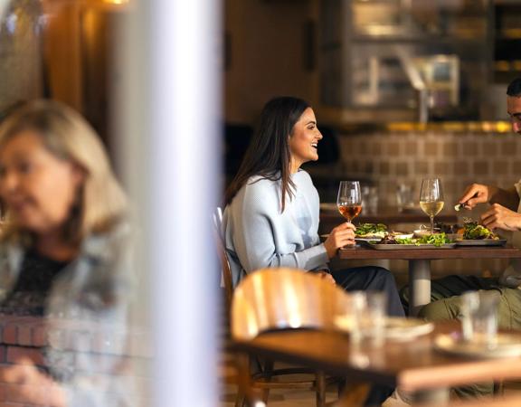 Two people enjoying food and wine at Kisa, a Mediterranean restaurant on Cuba Street in Te Aro, Wellington.