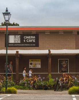 The brown and red exterior of Lighthouse Cinema Pāuatahanui.
