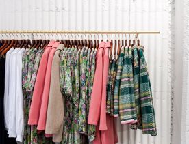 A clothing rack with jackets and dresses at twenty seven names.