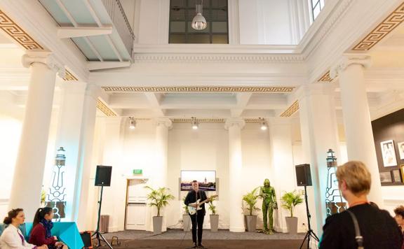A guitarist is performing at Courtenay Creative, a restored heritage building on Courtenay Place in Te Aro, Wellington.