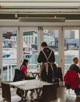 A waiter serves customers at Dockside on Queens Wharf.