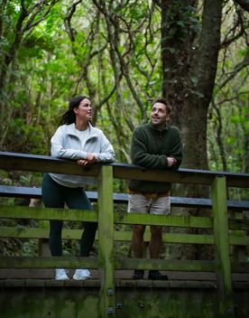 Two hikers stand on a bridge on the Colonial Knob Walkway to Rangituhi Lookout.