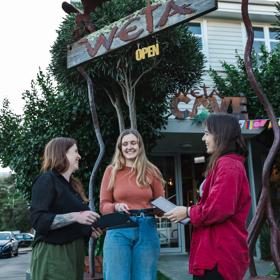 The people standing outside of Wētā Cave, the location of Wētā Workshop Tours in Miramar, Wellington.