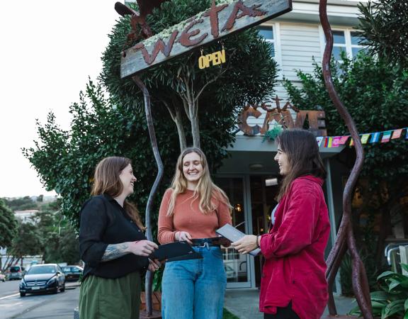 The people standing outside of Wētā Cave, the location of Wētā Workshop Tours in Miramar, Wellington.