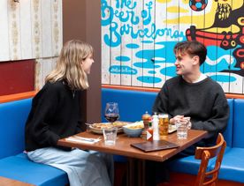 Two people dining at El Matador in the outdoor courtyard area.