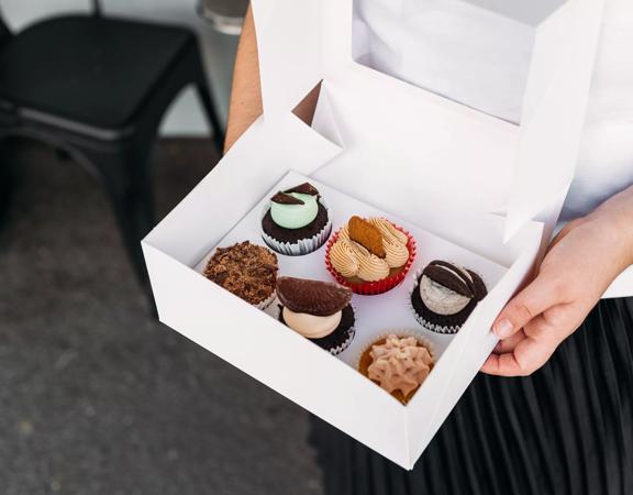 A box with 6 cupcakes inside from The Cake Cafe Plimmerton.