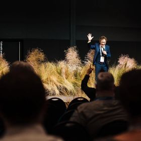 A presenter on a stage at the WaterNZ conference.