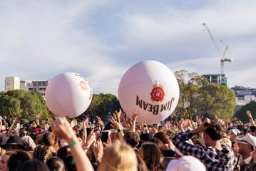 Two huge beach balls bouncing above a crowd at the Jim Beam Homegrown music festival in Wellington. 