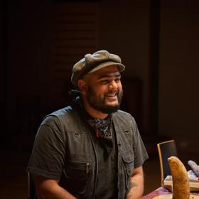 Aditya B. Parige smiling while sitting at a table.