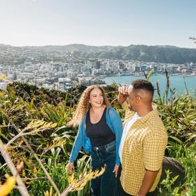 A young couple enjoy the view from Mount Victoria lookout in Wellington.
