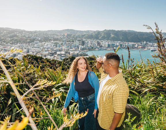 A young couple enjoy the view from Mount Victoria lookout in Wellington.