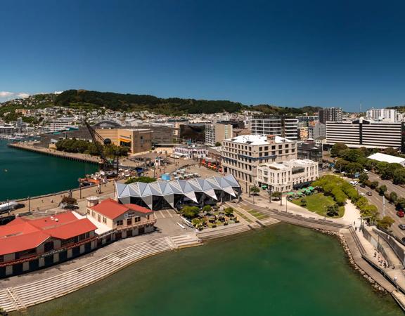 Aerial view of Wellington showing the waterfront and buildings such as Te Papa, Tākina, and the Boatshed.