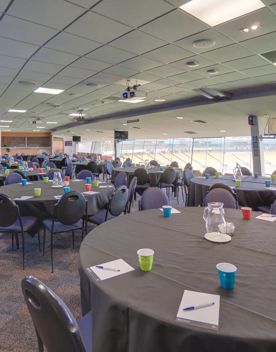 15 large tables in the members lounge and Hnry Stadium Function Centre, each table has 6 chairs, a black table cloth, notepads and water.