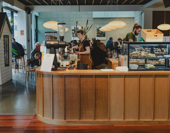 The front counter at Twenty Eight Cafe, located at 28 Cornwall Street in Lower Hutt, with two people working.