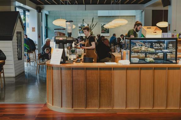 The front counter at Twenty Eight Cafe, located at 28 Cornwall Street in Lower Hutt, with two people working. 