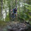 A downhill mountain biker jumps on the Spoonhill trail in Wainuiomata.