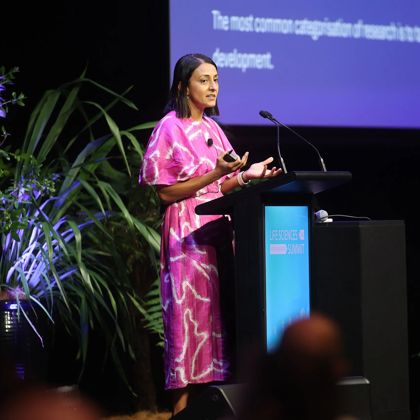 Person speaking at a lecturn at Life Sciences Summit 2025.
