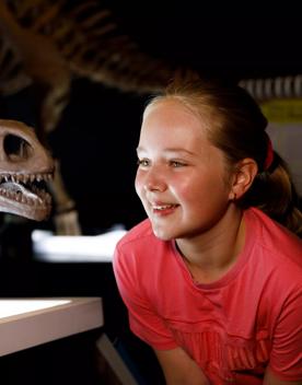 A visitor to Dinosaurs of Patagonia gets up close to a dinosaur cast in Perth.