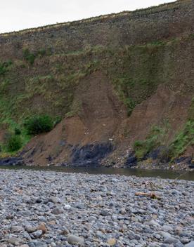 The screen location of Te Mārua  cliffs, where a river flows against vertical cliffs on the foothills of the Remutaka Range.