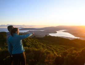 Two people look at the sunset from Rangituhi/Colonial Knob Walkway.