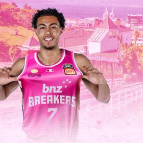 NZ Breakers 2024/25 guard, Mojave King in front of a pink-filtered Wellington Cable Car background image.